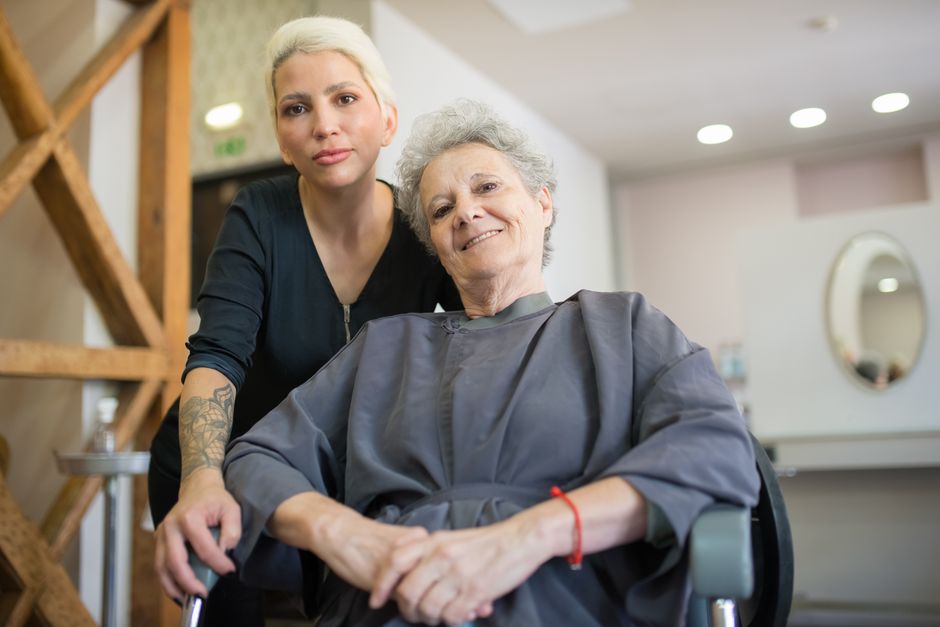 A stylist working with a longtime client in a neighborhood salon